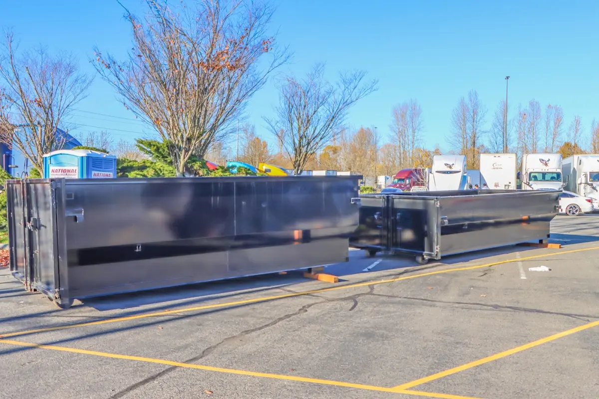 Professional dumpster rental service with roll-off container on residential driveway in Frankstown